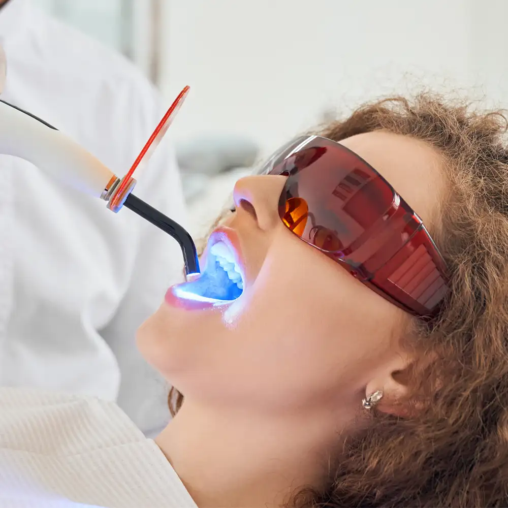 girl lying chair while dentist keeping ultraviolet tool copy